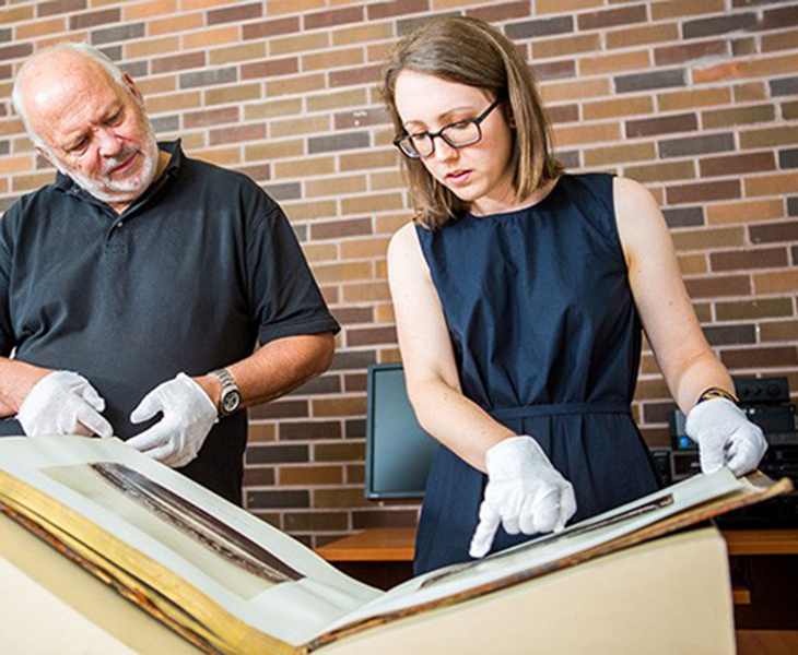 Chris James and Alex Mills examining an item from Special Collections